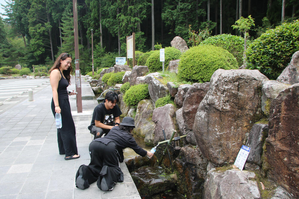 3-4　名水の試飲をする学生.jpg